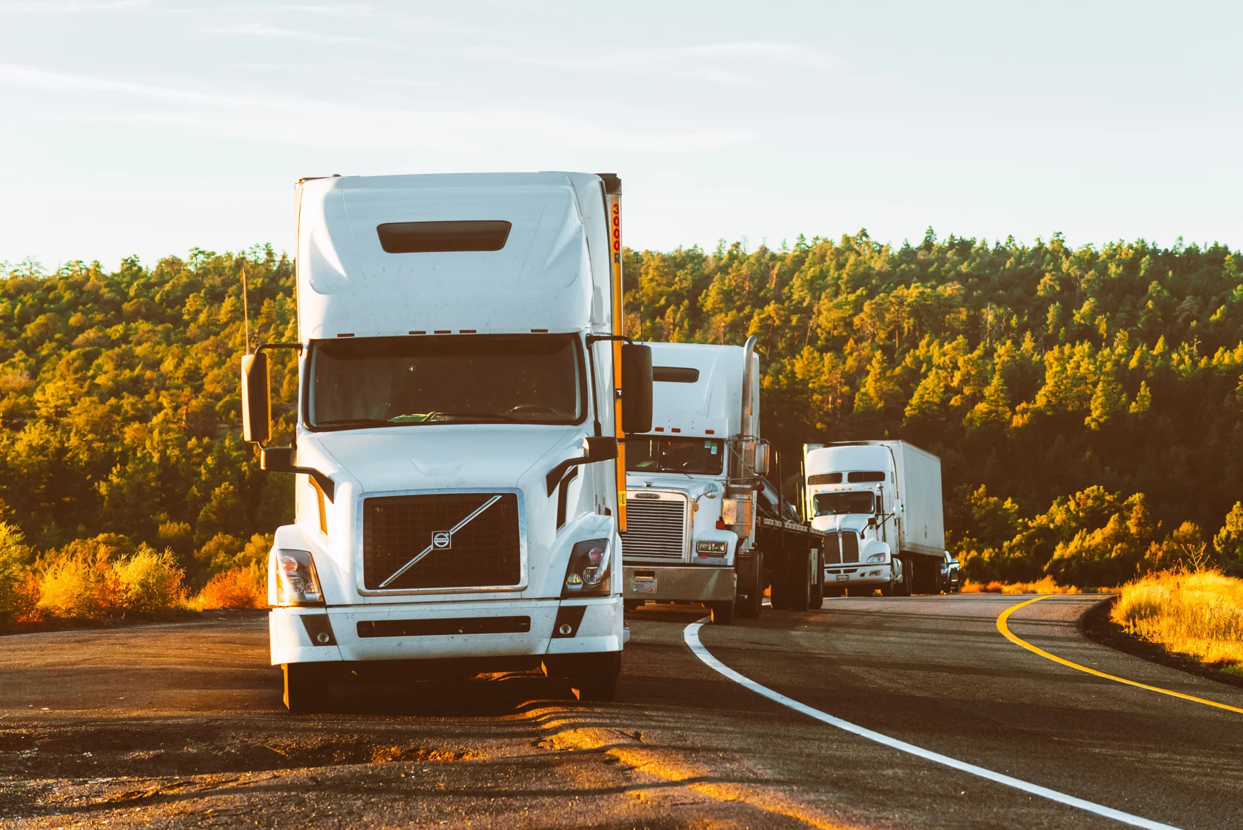 American semi truck with a trailer on an open country road